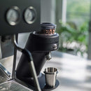 mahlkonig x64 sd single dose grinder in black with hopper next to ascaso baby t espresso machine
