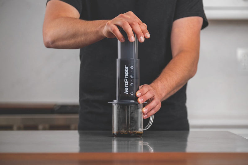 Person brewing coffee with an AeroPress
