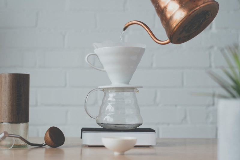 Person brewing coffee on a V60