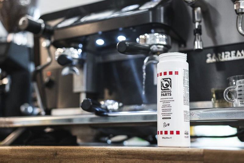 Espresso machine cleaner in front of an espresso machine