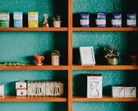Coffee bags and retail items on the shelf at a cafe