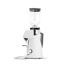 A white electric coffee grinder with a clear hopper on top, shown from a side profile view against a solid white background.