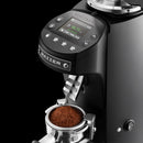 Mazzer coffee grinder with ground coffee in a container on a black background
