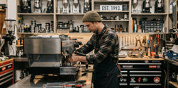 coffee tech working on an espresso machine
