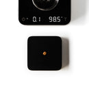 acaia umbra lunar scale black in use on an espresso machine