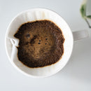 kalita style white ceramic dripper with coffee